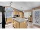 Bright kitchen with central island, granite countertops, and stainless steel appliances at 9909 Masked Duck Ave, Las Vegas, NV 89117