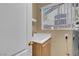 Bright laundry room with a utility sink and a view from the window at 9909 Masked Duck Ave, Las Vegas, NV 89117