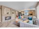 Open-concept living room with fireplace flows into bright eat-in kitchen at 9909 Masked Duck Ave, Las Vegas, NV 89117