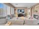 Living room includes a large sectional, fireplace, and lots of natural light at 9909 Masked Duck Ave, Las Vegas, NV 89117