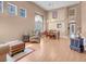 Bright and airy living room featuring hardwood floors, large windows, and a cozy dining area at 9909 Masked Duck Ave, Las Vegas, NV 89117
