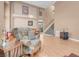 Inviting living room with wood floors, staircase, and comfortable armchair at 9909 Masked Duck Ave, Las Vegas, NV 89117