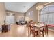 Bright living room featuring hardwood floors, neutral paint, and dining table at 9909 Masked Duck Ave, Las Vegas, NV 89117