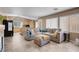 Bright living room with large gray sectional and kitchen overlooking space at 9909 Masked Duck Ave, Las Vegas, NV 89117