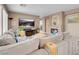 Open living room with a large sectional, fireplace, and bright natural light at 9909 Masked Duck Ave, Las Vegas, NV 89117