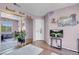 Home office featuring hardwood floors, stylish decor, large window, and sliding mirror closet at 9909 Masked Duck Ave, Las Vegas, NV 89117
