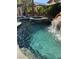 Backyard pool featuring a spa and rock waterfall creating a private tropical oasis for relaxation and fun at 9909 Masked Duck Ave, Las Vegas, NV 89117