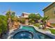 Lush backyard featuring a sparkling pool with a rock waterfall at 9909 Masked Duck Ave, Las Vegas, NV 89117