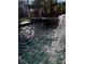 Backyard pool featuring a rock waterfall and a covered outdoor living space for relaxation and entertaining at 9909 Masked Duck Ave, Las Vegas, NV 89117