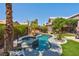 Beautiful pool and spa surrounded by lush landscaping in a private backyard at 9909 Masked Duck Ave, Las Vegas, NV 89117