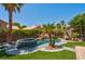 Inviting pool area with a waterfall feature and tropical landscaping at 9909 Masked Duck Ave, Las Vegas, NV 89117