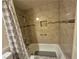 Bathtub and shower with gray tile, shower curtain, and niche at , Las Vegas, NV 89128