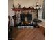 Living area with a stone fireplace mantel, decorative lamps and wood-look flooring at , Las Vegas, NV 89128