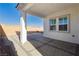 An outdoor patio featuring neutral-toned pavers and a partial view of the grassy yard at , Las Vegas, NV 89166
