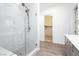 Primary bathroom with a glass shower, double sink vanity, and an open closet at , Las Vegas, NV 89166