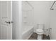 Bathroom with white toilet and shower-tub combo with white surround and bronze hardware at , Las Vegas, NV 89166