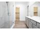 Primary bathroom with a glass shower, double sink vanity, and an open closet at , Las Vegas, NV 89166