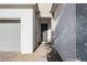 Home front entrance featuring a covered porch and a tiled walkway leading to the front door at , Las Vegas, NV 89166