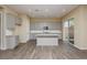 Bright kitchen featuring an island, gray cabinets, and a sliding door leading outside at , Las Vegas, NV 89166