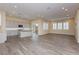 Spacious living room with wood-look flooring, ample natural light, and open kitchen access at , Las Vegas, NV 89166