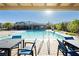 Resort style swimming pool with lounge chairs and community amenities in the background at , Las Vegas, NV 89166