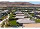 An aerial view shows a home in a community with mountain views and manicured landscaping at 10349 Bressana Dr, Las Vegas, NV 89135