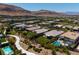 An aerial view features lush green lawns, winding walkways, and a refreshing pool within a community at 10349 Bressana Dr, Las Vegas, NV 89135
