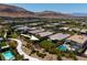 Aerial view of a home near community green space, walkway, and pool with mountain views at 10349 Bressana Dr, Las Vegas, NV 89135