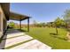 A spacious backyard features artificial turf, with modern pavers leading to an outdoor living space at 10349 Bressana Dr, Las Vegas, NV 89135