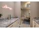 Chic bar area with granite countertops and modern cabinetry, adjacent to the dining space at 10349 Bressana Dr, Las Vegas, NV 89135
