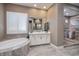 Luxurious bathroom featuring a soaking tub and glass-enclosed shower at 10349 Bressana Dr, Las Vegas, NV 89135
