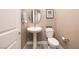 Cozy powder room featuring a pedestal sink and modern fixtures at 10349 Bressana Dr, Las Vegas, NV 89135