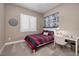 Bright bedroom with a desk, modern art, and a large window with shutters at 10349 Bressana Dr, Las Vegas, NV 89135