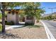 Welcoming community entrance featuring stone accents, xeriscaping, and prominent signage at 10349 Bressana Dr, Las Vegas, NV 89135