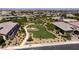 Aerial view showcasing a lush community park with walking paths and green spaces amidst beautiful homes at 10349 Bressana Dr, Las Vegas, NV 89135