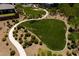 Expansive green space defines this aerial view of the community park featuring manicured lawns and walking paths at 10349 Bressana Dr, Las Vegas, NV 89135
