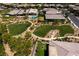An aerial view showcases a community park with lush green spaces, bordered by walking paths at 10349 Bressana Dr, Las Vegas, NV 89135