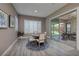 Cozy dining area with natural light, stylish furnishings, and a seamless transition to the outdoor patio at 10349 Bressana Dr, Las Vegas, NV 89135