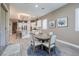 Bright dining area with a view into the kitchen, featuring modern decor and comfortable seating at 10349 Bressana Dr, Las Vegas, NV 89135