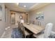 Inviting dining room with a rustic wooden table, designer rug, and neutral wall colors at 10349 Bressana Dr, Las Vegas, NV 89135