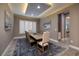 Elegant dining room featuring a large wooden table, stylish chairs, and shuttered windows at 10349 Bressana Dr, Las Vegas, NV 89135