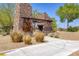 Community entrance features a stone facade, desert landscaping, and well-maintained grounds at 10349 Bressana Dr, Las Vegas, NV 89135