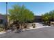 A modern home with desert landscaping, a paved driveway, and an attached two-car garage at 10349 Bressana Dr, Las Vegas, NV 89135