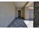 Stylish front entryway with a modern door, gray brick accents, and a paved walkway at 10349 Bressana Dr, Las Vegas, NV 89135