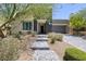 Charming single-story home with desert landscaping and a stone walkway leading to the front door at 10349 Bressana Dr, Las Vegas, NV 89135