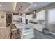 Open kitchen with white cabinetry, granite countertops, and a spacious center island at 10349 Bressana Dr, Las Vegas, NV 89135