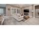 Open concept living room with tile floors, modern furniture, and stylish overhead lighting at 10349 Bressana Dr, Las Vegas, NV 89135