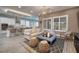 Open concept living room with tile floors, comfortable seating, and a view into the kitchen at 10349 Bressana Dr, Las Vegas, NV 89135