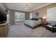 Spacious bedroom with a chandelier, large windows, and stylish furniture at 10349 Bressana Dr, Las Vegas, NV 89135