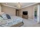 Bright bedroom with large windows, modern lighting, and neutral-colored carpet at 10349 Bressana Dr, Las Vegas, NV 89135